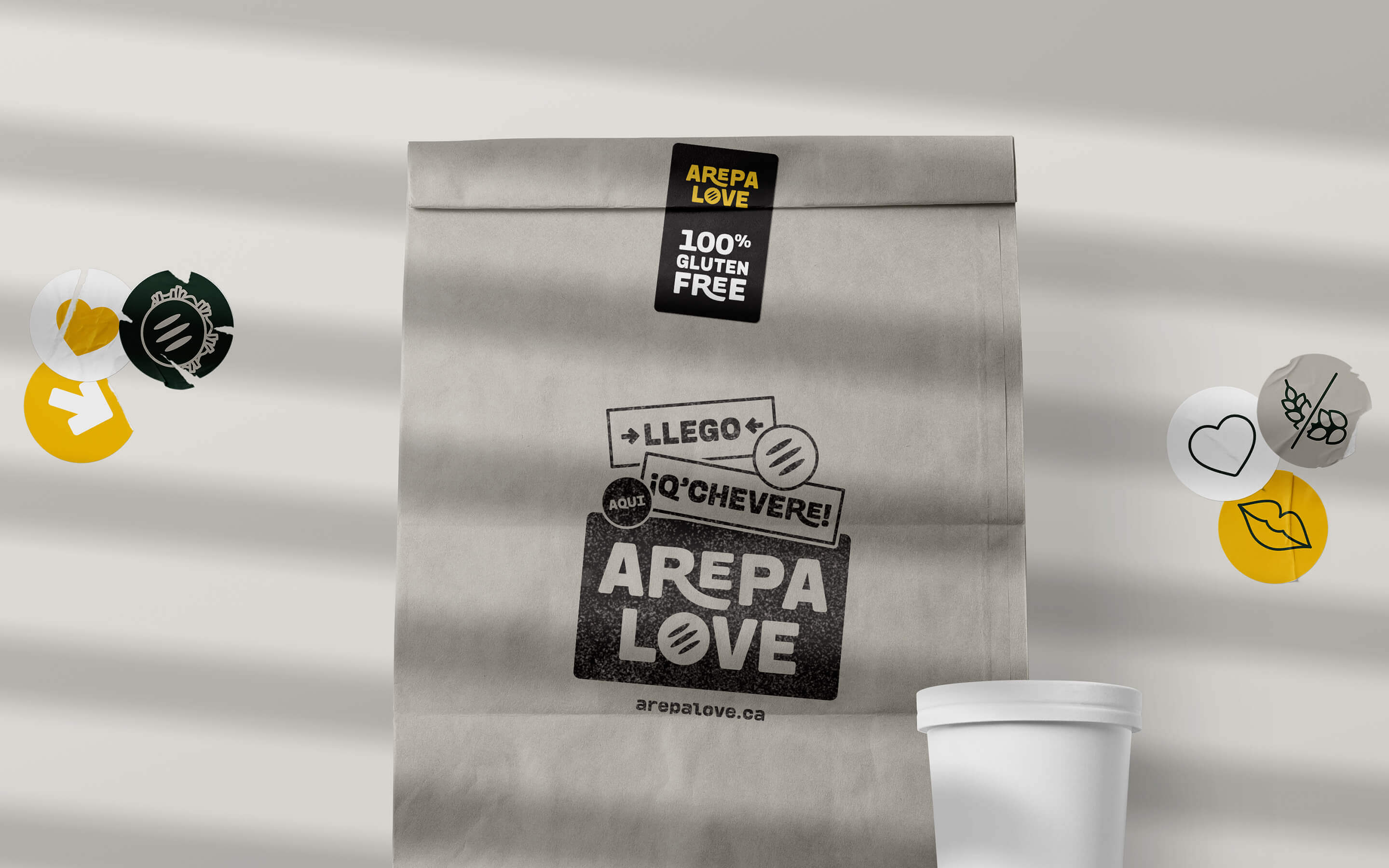Arepa Love's takeaway paper bag with custom stamp and stickers.